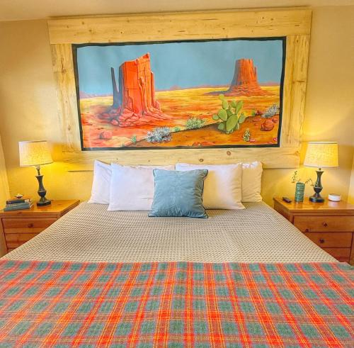 a bedroom with a bed with a painting on the wall at Hózhó King Mokee Shared Kitchen, Pets Ok #2 in Bluff