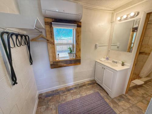 a bathroom with a sink and a mirror and a window at King Five Mokee Motel Pets OK Shared Kitchen in Bluff