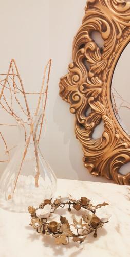 a glass vase and a mirror on a table at Venice in Nottingham
