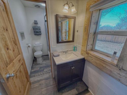 a bathroom with a sink and a toilet and a window at King Bear Mokee Pets OK, Shared Kitchen! #4 in Bluff