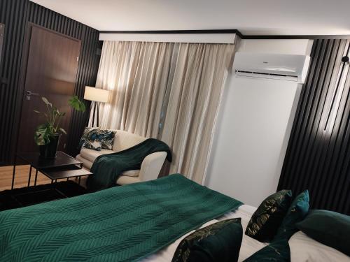 a hotel room with a bed and a chair at Willa Sandomierska in Sandomierz