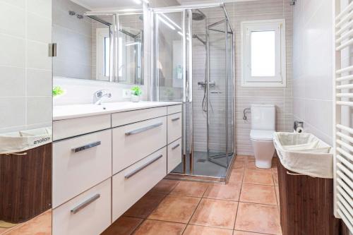 a bathroom with a shower and a sink and a toilet at The Denia Hideaway in Denia