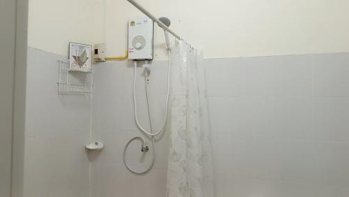 a bathroom with a shower with a shower curtain at Pai Town Home in Pai