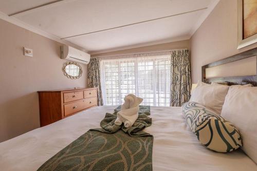a bedroom with a large bed with a large window at Ulifalodge whitehouse in Hillcrest