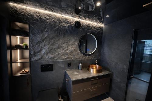 a bathroom with a sink and a mirror at Studio 28 in Narvik
