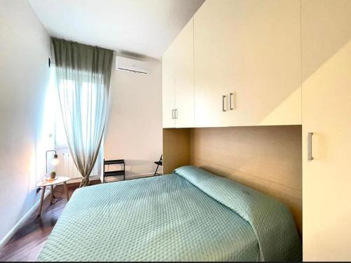a bedroom with a green bed and a desk at Anzio lighthouse terrace family-group friendly in Anzio