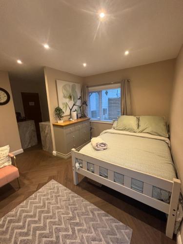 a bedroom with a large bed and a window at 1 double bed studio with private access and parking in Plymouth