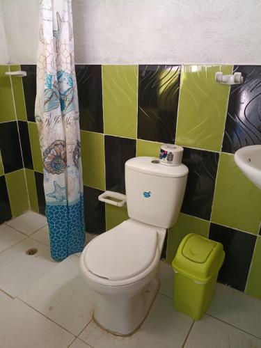 a bathroom with a toilet and a sink at Casa hostal playa coral in Capurganá