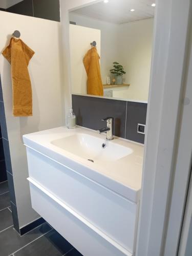 a bathroom with a sink and a mirror at "City Sleep" in Nykøbing Mors