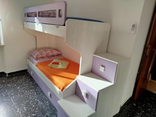 a bedroom with a bunk bed with white drawers at Casa Milda in Capoliveri