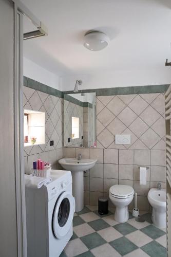 a bathroom with a washer and a toilet and a sink at Gragnano in in Gragnano