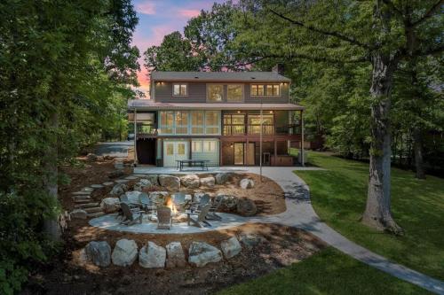 a large house with a fire pit in front of it at Emerald Shores - Lakefront, Private Dock & Fire Pit in Moneta