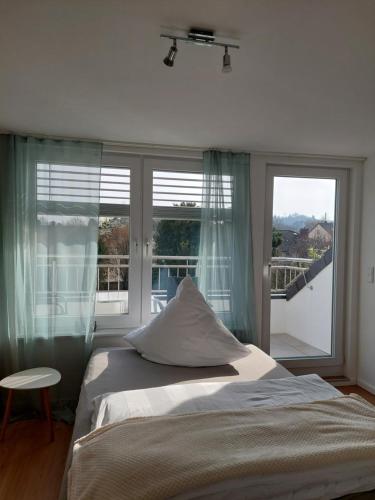 a bedroom with a bed and a large window at Ferienwohnung Senfnest in Ober-Ramstadt