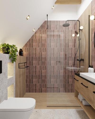 a bathroom with a shower with a toilet and a sink at Prime - Event & Relax Resort in Jaszczurowa