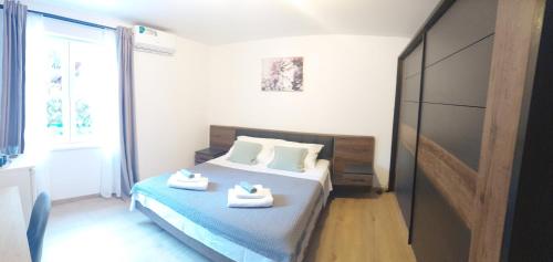 a bedroom with a bed with two shoes on it at Room Depikolo 2 in Krk