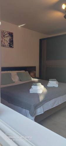 a bedroom with a bed with towels on it at Room Depikolo 2 in Krk