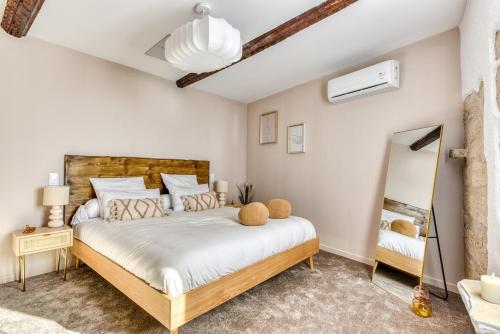a bedroom with a large bed and a mirror at La Sensuelle Suite with spa in Vendres