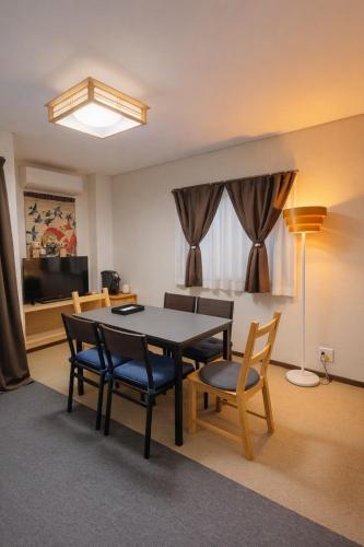 a dining room with a table and chairs in a room at Kyoto Toka inn京都東華inn in Kyoto
