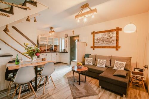 a living room with a couch and a table at Domek na Przylasku in Grywałd