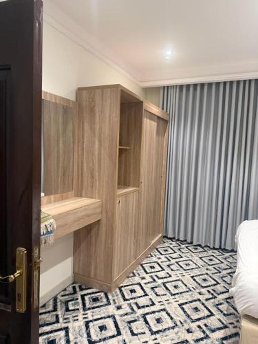 a room with a bedroom with a bed and a desk at Dar Al-Areed in Medina
