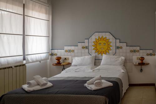 a bedroom with a large bed with towels on it at B&B Tirreno- Finestra sul Mare in Contrada Mastrissa