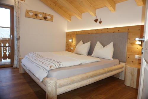 a bedroom with a large bed with a wooden headboard at Niederhaushof in Santa Valpurga