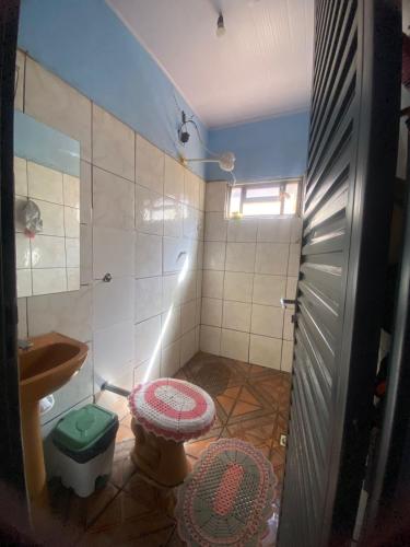 a small bathroom with a toilet and a sink at Quarto para o Moto GP in Goiânia