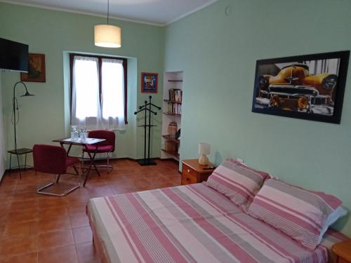 a bedroom with a bed and a table and a window at Ca' melindetta in Recetto