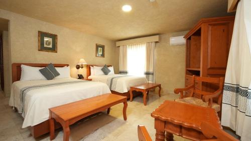 Llit o llits en una habitació de Hotel Marques Del Valle