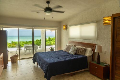 a bedroom with a bed and a view of the ocean at Casa Portofino in Chuburná