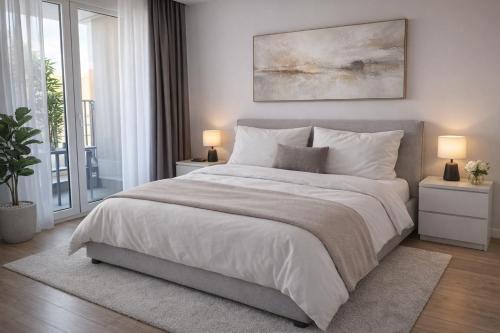 a bedroom with a large white bed with two lamps at Extra Apartman Palata in Banja Luka