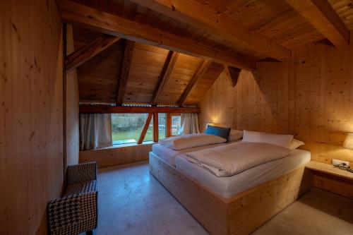 a bedroom with a bed in a wooden house at Reichart Apartment in Lochau