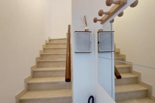 a staircase in a house with a glass door at Casa do jato in Muros