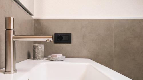 a bathroom with a white tub and a sink at Silva: The Alpine Chalet in Livigno