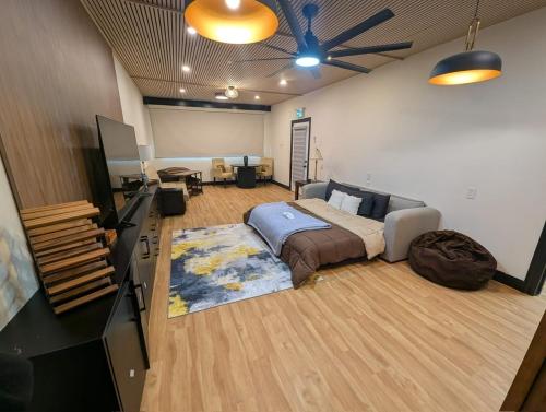 a large living room with a bed and a couch at Spacious King Pull Out Suite Beamsville in Beamsville
