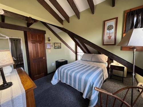 a bedroom with a bed and a table with a lamp at Watership Inn in Provincetown