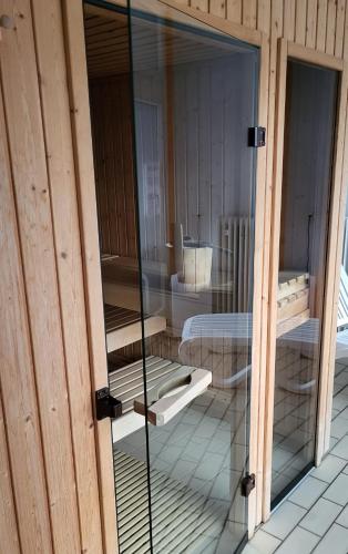 a glass door of a room with two beds at FeWo Hänsel in Schönwald