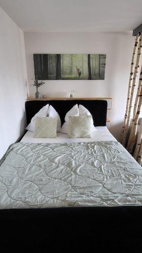 a bedroom with a large white bed with two pillows at FeWo Hänsel in Schönwald