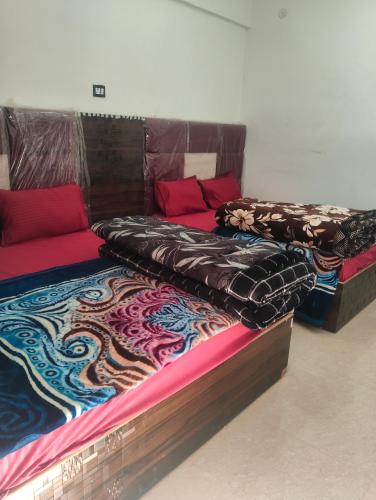 two beds sitting next to each other in a room at Balaji hotel in Badrinath