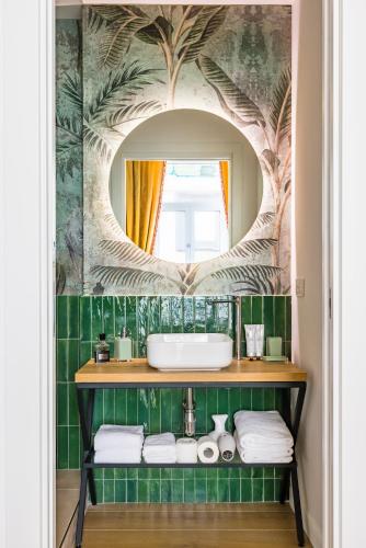 a bathroom with a sink and a mirror at Themis Toledo - Private Spa Apartment in Naples