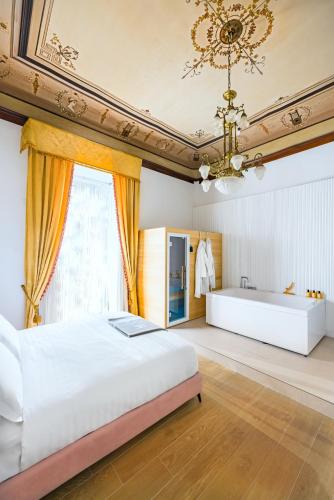 a bedroom with a large bed and a bath tub at Themis Toledo - Private Spa Apartment in Naples