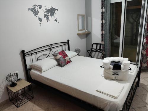 a bed with white sheets and pillows in a room at liogerma i in Agios Ioannis Kaspaka