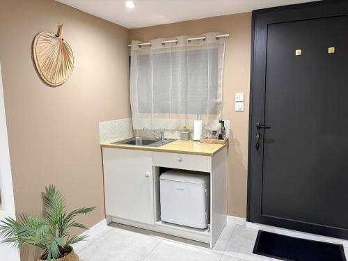 a small kitchen with a sink and a counter at Studio indépendant a 20min des plages in Castelnau-de-Guers