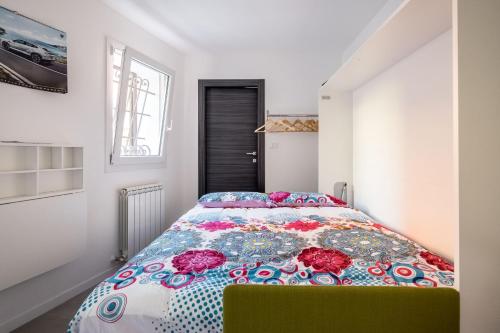 a bedroom with a bed with a colorful comforter at Piccola dimora Casalecchio vicino al GranReno e Unipol in Zola Predosa