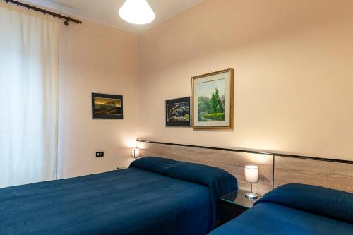 a bedroom with a blue bed and a window at Bed and Breakfast L'Annunziata in Sulmona