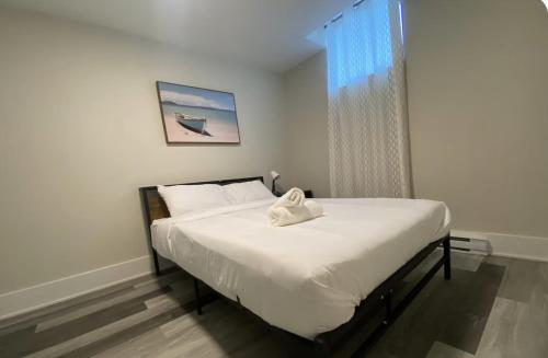 a bedroom with a bed with a towel on it at Cozy stays in Montréal