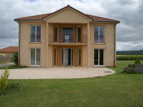 a house with a balcony on top of a yard at Cosy vacation home near the sea in Verdun-sur-Meuse