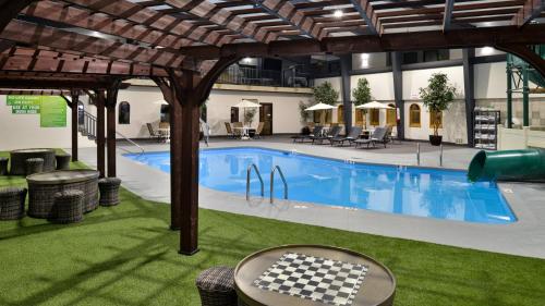 a swimming pool with a checkeredkered table next to it at Holiday Inn Great Falls-Convention Center by IHG in Great Falls