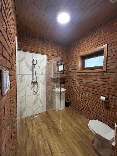 a bathroom with a glass shower and a toilet at Hotel Eliot in Łomża