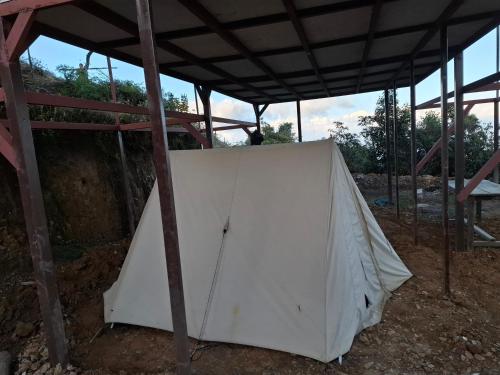 a white tent under a roof in a field at Sunya Homestay in Kirāntīchhāp